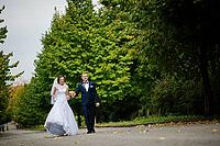 Wedding couple walking at green park [IBR123675072]
