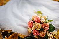 Wedding bouquet background wedding dress in yellow autumn leaves [IBR123675073]