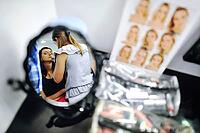 Young brunette bride applying wedding make-up by make-up artist [IBR123675095]