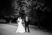 Wedding couple walking at green park [IBR123675100]