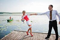 Wedding beautiful couple in traditional dress on the dock [IBR123675124]