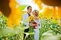 Wedding beautiful couple in traditional dress at the sunflower [IBR123675127]