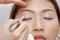 Woman applying cosmetic with applicator. Make-up treatment [IBR123713326]