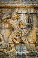 Small figure of a female archer carved on the wall in the Borobudur temple in Java, Indonesia [IBR123713330]