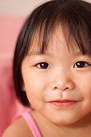 Close-up shot of a young Asian girl with smile on her face [IBR123713371]