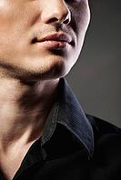 Closeup portrait of a sexy male model on dark grey background [IBR123723151]