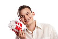 Close-up portrait of smiling man holding gift isolated on white background [IBR123723166]
