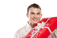 Close-up portrait of smiling man holding gift isolated on white background [IBR123723167]
