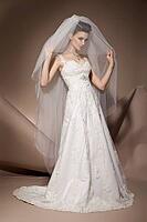 The beautiful young woman posing in a wedding dress [IBR123723174]