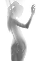 Silhouette of young sexy woman on white background leaning back. Studio shot [IBR123723191]