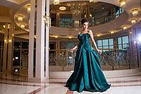 Portrait of beautiful young brunette in dress against of illumination [IBR123723219]