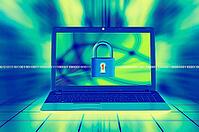 A laptop screen displays a padlock with binary code, symbolizing digital security and cybersecurity themes [IBR123760802]