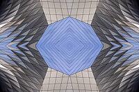 Abstract photography with a symmetrical, diamond-shaped shape that consists of repetitive lines and surfaces in shades of gray, white and blue and creates an impression of rhythm, depth and cool geometric harmony [IBR123760822]