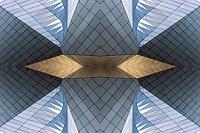 Abstract photography with symmetrical, sharp geometric forms of architecture in cool shades of gray and blue as well as warm beige, emphasizing the contrast of light, shadow and structure [IBR123760843]