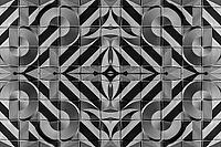 Abstract photography with symmetrical, abstract patterns that consist of sharp geometric and wavy shapes in shades of black, white and gray [IBR123760846]