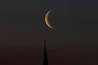Crescent moon with waning moon over the spire of the pilgrimage church of St. Aegidius in Schildthurn, dawn, dawn, Lower Bavaria, Bavaria, Germany [IBR123760852]