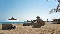 Peaceful sandy beach on the blue sea with empty umbrellas and palm trees, Shoni Bay, Egypt [IBR123769641]