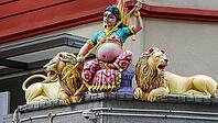 An armed figure on a temple flanked by two lions in colorful depiction, Singapore, Singapore [IBR123769643]