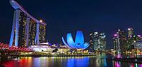 Impressive city view at night with illuminated modern buildings and a tranquil expanse of water, Singapore, Singapore [IBR123769653]