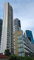 Dramatic perspective of high-rise buildings with glass facades standing out against the blue sky, Singapore, Singapore [IBR123769658]