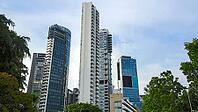 Towering modern skyscrapers with glass facades against a blue sky in an urban setting, Singapore, Singapore [IBR123769659]