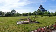 A well-maintained park with benches and the Millennium Tower in Magdeburg in a quiet atmosphere, Magdeburg, Germany [IBR123769721]