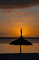 Beach sunset, parasol, Flic-en-Flac, Mauritius [IBR123774797]