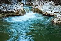 Raging clean fresh mountain river flowing between rocks [IBR123878895]