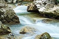 Raging clean fresh mountain river flowing between rocks [IBR123878900]