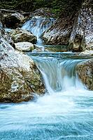Raging clean fresh mountain river flowing between rocks [IBR123878910]