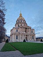 Stunning exterior view of the gilded Dome des Invalides in Paris, France. The cobblestone courtyard and the Saint-Louis Cathedral at dusk. Monumental Baroque architecture [IBR123895595]