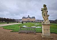 Maincy, France - December 11, 2025: Majestic Chateau de Vaux-le-Vicomte with view from the garden. Gravel paths with symmetrical manicured hedges, and antique classical statues of baroque masterpiece [IBR123895600]