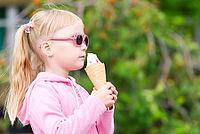 Little girl eating icecream [IBR123980442]