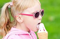 Little girl eating icecream [IBR123980443]