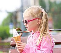 Little girl eating icecream [IBR123980447]