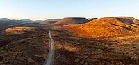 Aerial view, road leading through dry desert landscape, hills in Damaraland, Namibia [IBR123990973]