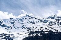 Dramatic snow-capped summit above Kandersteg Bernese Alps mountain landscape with deep blue sky [IBR123990990]
