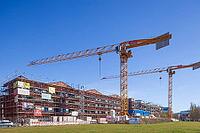 Shell of residential buildings with construction cranes in the Überseestadt of Bremen, scaffolding, construction site, Bremen [IBR123999829]