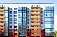 Facade fragment of new bright colorful modern residential building [IBR124036431]