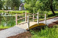 Small wooden bridge with railings at the park in summer sunny day [IBR124036445]