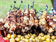 Cooking traditional appetizing hot shish kebab or shashlik on metal skewers [IBR124036453]