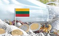 Lithuanian flag with euro currency coins and a medical mask on rocky ground.Eurozone healthcare costs, medical funding challenges and the financial weight of modern services connected to Lithuania [IBR124084109]