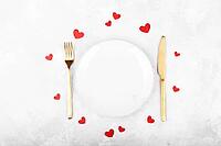 Romantic table setting with golden cutlery on white stone table.Valentine's day card template [IBR124084179]