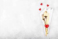 Romantic table setting with golden cutlery on white stone table.Valentine's day card template [IBR124084181]