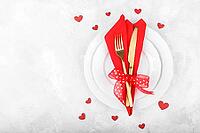 Romantic table setting with red napkin and golden cutlery on white stone table.Valentine's day card template [IBR124084182]