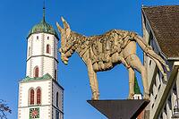 Donkey sculpture Donkey Monument (Biberacher Esel) by Peter Lenk on the market square and in the background the blue sky and the top of the church tower with the clock, St Martin's parish church, Biberach, Biberach an der Riß, Upper Swabia, Baden-Württemb [IBR124200507]