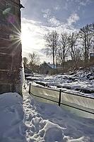 The ruins of the historic Borgvik Ironworks. Industrial stone architecture on a river in winter with snow and blue skies. Cultural heritage site in picturesque countryside in Värmland, Sweden [IBR124200527]