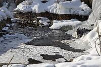 The ruins of the historic Borgvik Ironworks. Industrial stone architecture on a river in winter with snow and blue skies. Cultural heritage site in picturesque countryside in Värmland, Sweden [IBR124200529]