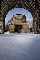 The ruins of the historic Borgvik Ironworks. Industrial stone architecture on a river in winter with snow and blue skies. Cultural heritage site in picturesque countryside in Värmland, Sweden [IBR124200531]