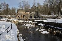 The ruins of the historic Borgvik Ironworks. Industrial stone architecture on a river in winter with snow and blue skies. Cultural heritage site in picturesque countryside in Värmland, Sweden [IBR124200533]